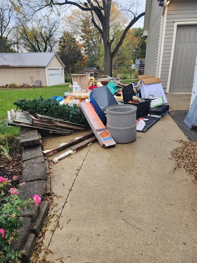 Dumpster being loaded with debris for Estate Cleanout Dumpster Rental in Flower Mound